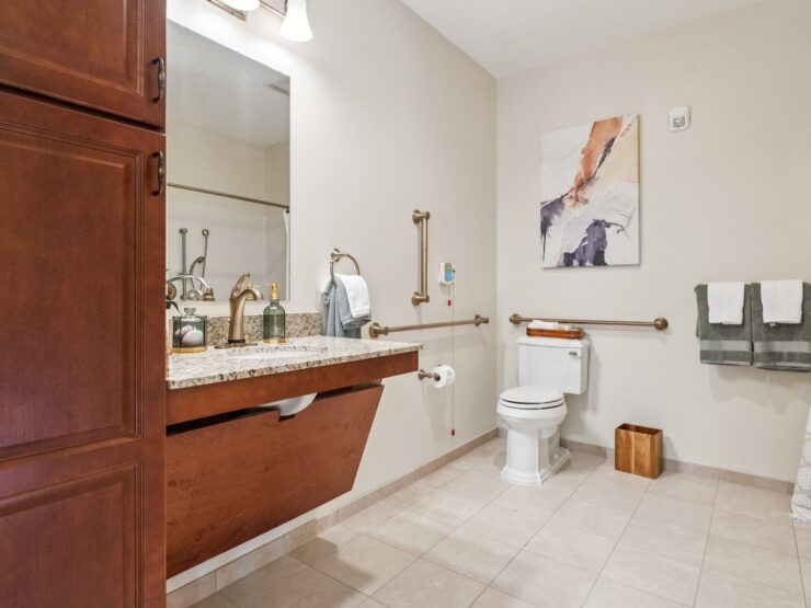 A serene bathroom featuring elegant fixtures, soft lighting, and thoughtful accessibility, promoting comfort.