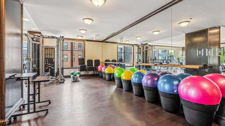 A vibrant fitness room filled with colorful exercise balls, promoting community wellness and activity.