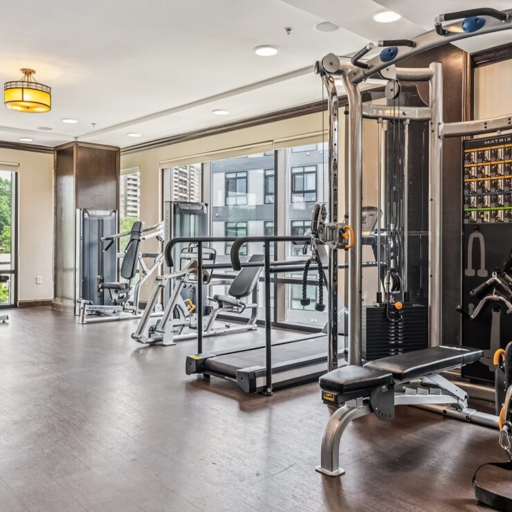 A bright fitness area with modern equipment and large windows, fostering community and wellness.