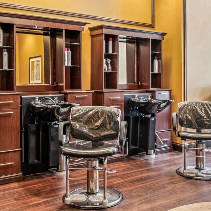 A welcoming salon space featuring stylish chairs and warm decor, perfect for community gatherings.