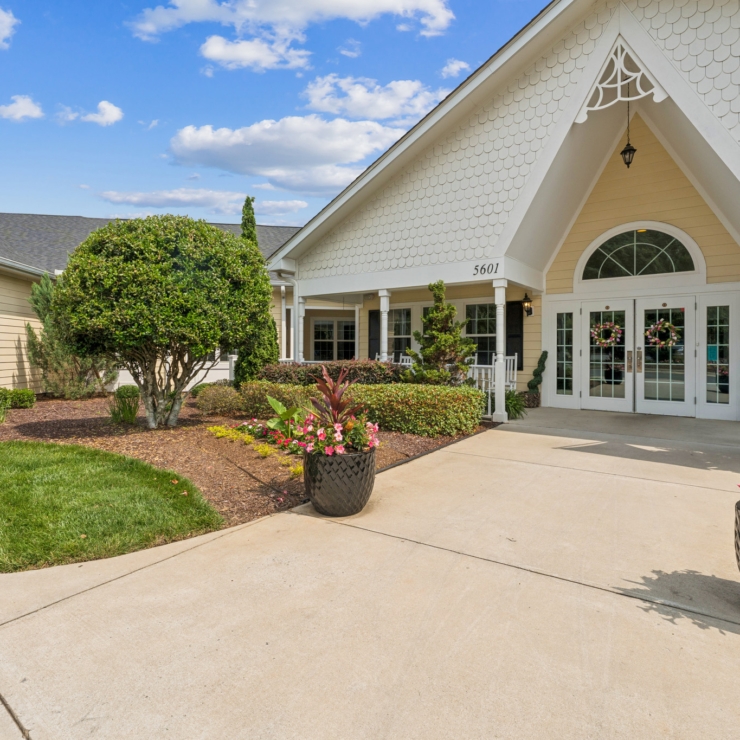 Welcoming entrance adorned with vibrant flowers, inviting a sense of community and comfort.