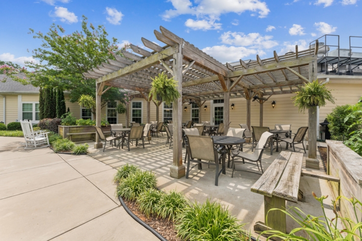 A welcoming outdoor space with shaded seating invites residents to relax and connect in nature.