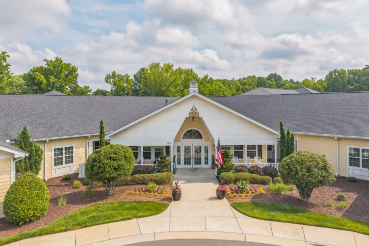 A welcoming retirement community featuring beautiful landscaping and a bright, inviting entrance.