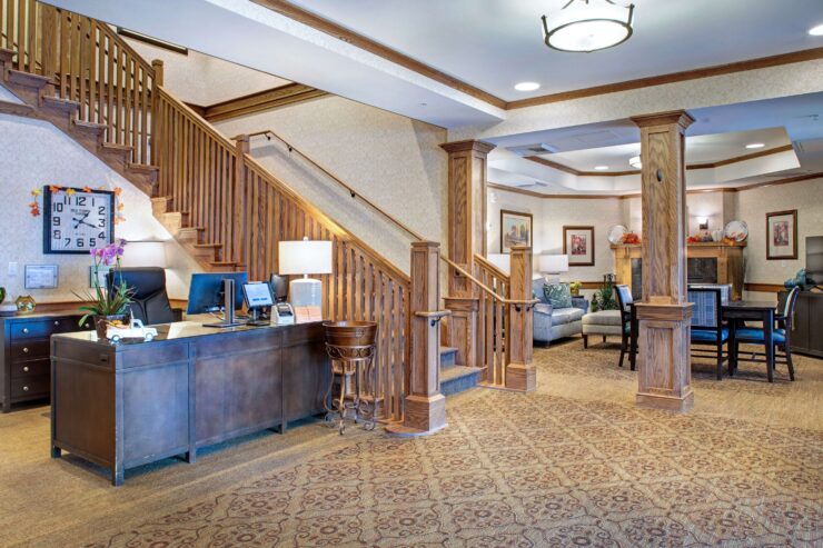 Warm, inviting lobby with comfortable seating, wooden accents, and a friendly reception area.