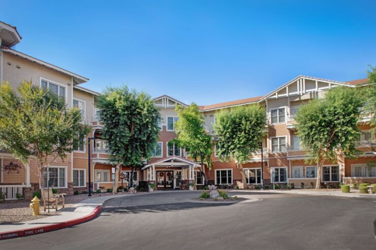Welcoming retirement community with shaded walkways and comfortable outdoor seating areas.