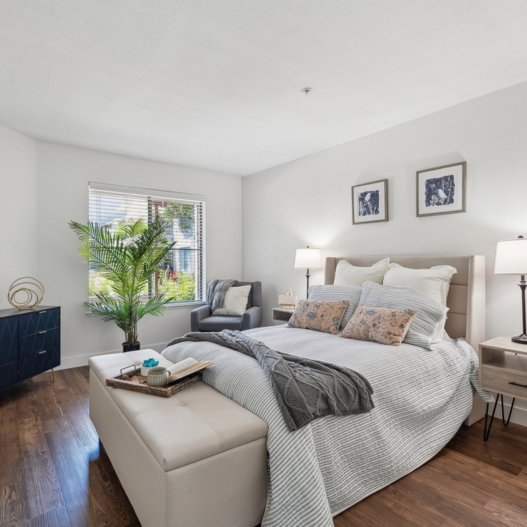 A cozy and inviting bedroom filled with natural light, perfect for relaxation and community living.