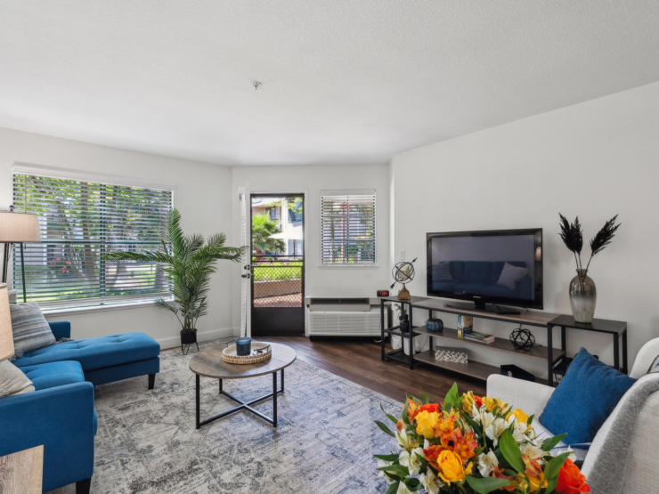 Bright and inviting, this community living space features comfortable seating and vibrant decor, fostering warmth and connection.