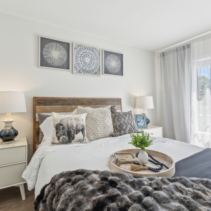 Bright and inviting bedroom with soft textures and warm accents, promoting relaxation and community spirit.