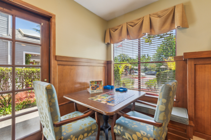 A cozy corner with a sunny view, inviting residents to enjoy games and warm conversations together.