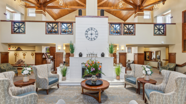 Welcoming lounge with elegant decor, inviting seating, and vibrant flowers, perfect for community gatherings.