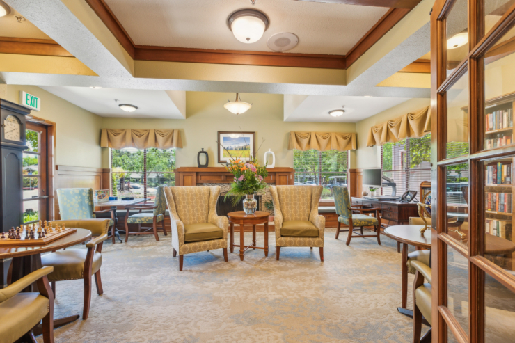 A welcoming common area features comfortable seating, natural light, and vibrant decor, inviting connection.