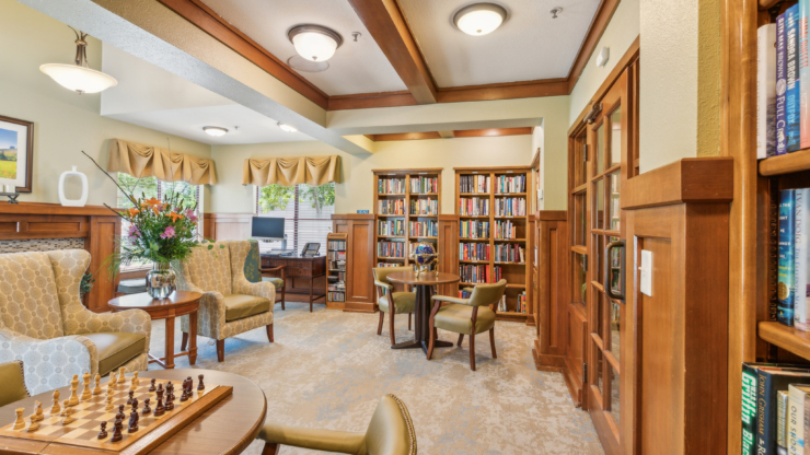 Bright and inviting, this common area features comfortable seating, bookshelves, and a chess set, fostering community connections.