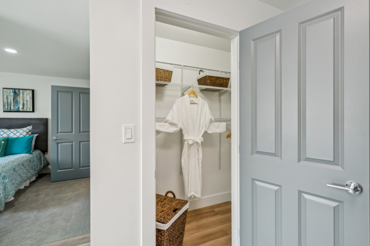 A cozy, inviting bedroom with soft decor, featuring a welcoming robe and warm, natural light.