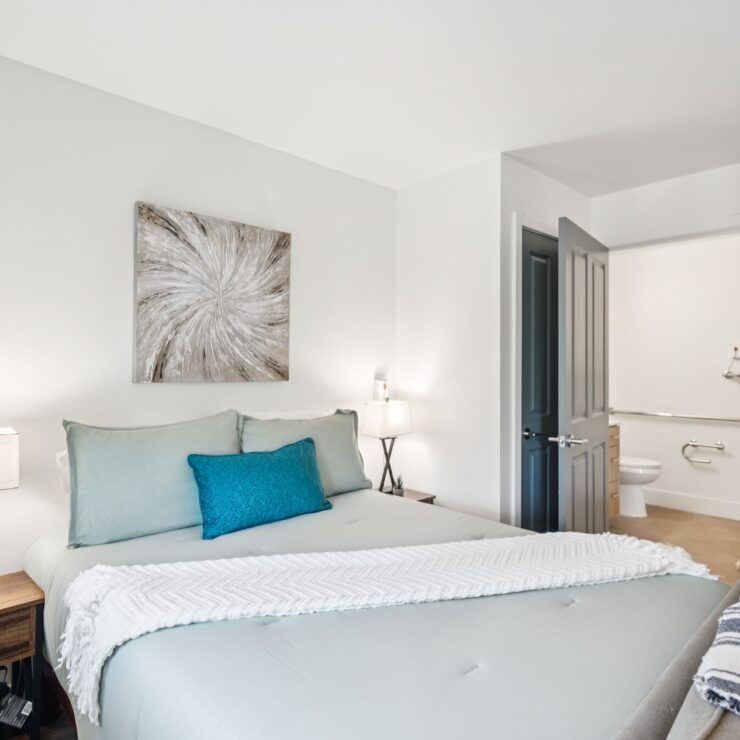 A bright, inviting bedroom with soft colors and thoughtful decor, fostering a sense of community and comfort.