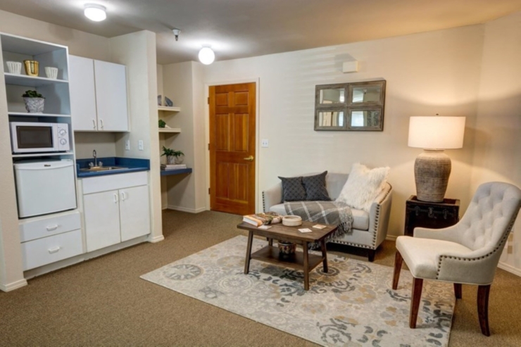 Bright and inviting, this cozy living space features comfortable seating and warm decor, fostering community.