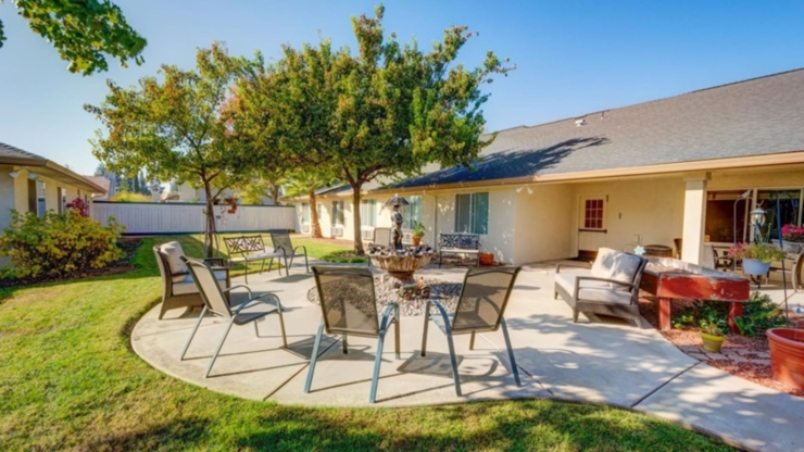 A serene courtyard featuring comfortable seating, vibrant greenery, and a soothing fountain invites community and relaxation.