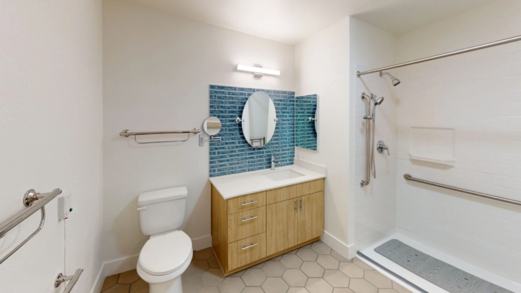A bright, inviting bathroom featuring modern amenities, promoting comfort and safety for residents.