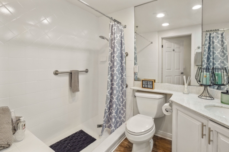 A bright, welcoming bathroom featuring modern amenities, promoting comfort and ease for residents.