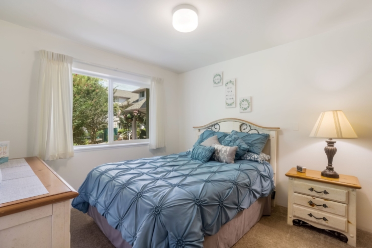 Inviting bedroom with soft decor, natural light, and a serene view, perfect for restful living.