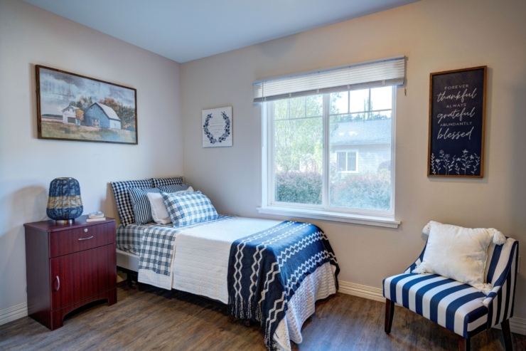 A serene bedroom filled with warmth, featuring cozy furnishings and natural light, inviting relaxation.