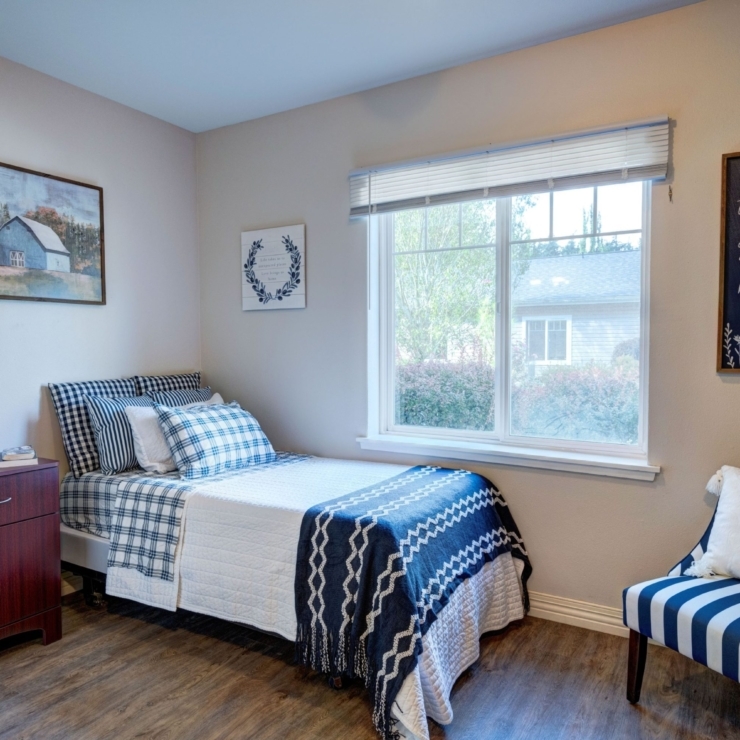 A serene bedroom filled with warmth, featuring cozy furnishings and natural light, inviting relaxation.