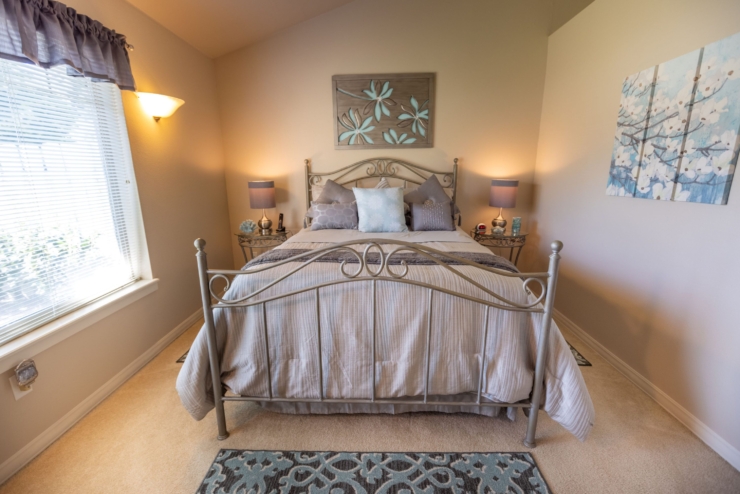 A serene bedroom filled with soft colors, inviting decor, and warm lighting, perfect for relaxation.