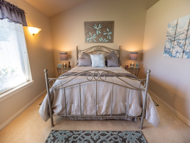 A serene bedroom filled with soft colors, inviting decor, and warm lighting, perfect for relaxation.