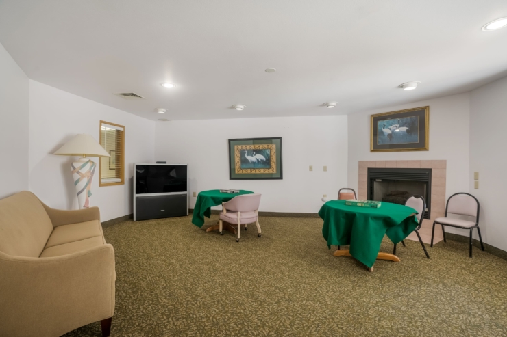 Relaxed gathering space with inviting seating and game tables, fostering connection and comfort.