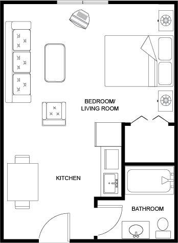 A welcoming layout featuring a comfortable living area and functional kitchen, perfect for community living.