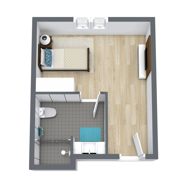 A cozy, inviting living space with warm wood flooring, designed for comfort and community.