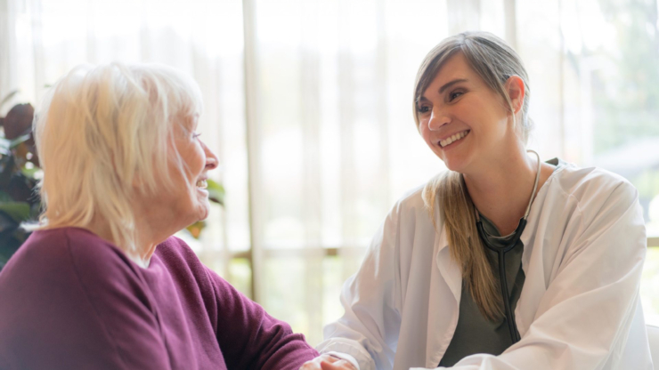 A warm, engaging moment between a caregiver and resident, fostering connection and comfort.
