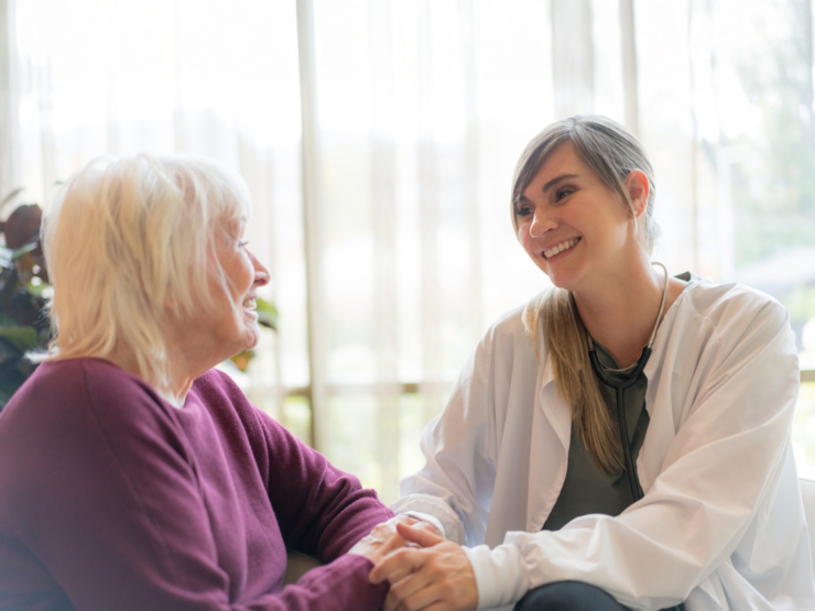 A warm, engaging moment between a caregiver and resident, fostering connection and comfort.