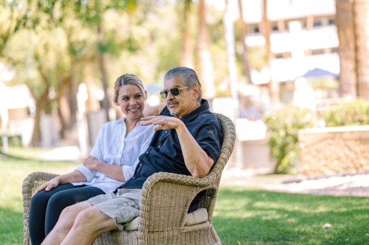 A joyful conversation unfolds in a sunlit garden, highlighting warmth and connection in the community.
