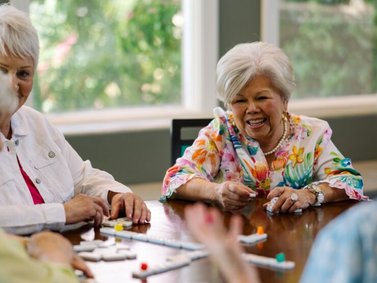 Lively interactions among friends enjoying games, filled with laughter and warmth in a bright space.