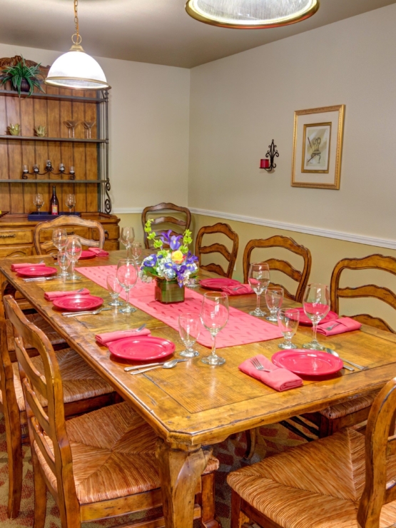 A warm dining space with a beautifully set table invites friendly gatherings and shared meals.