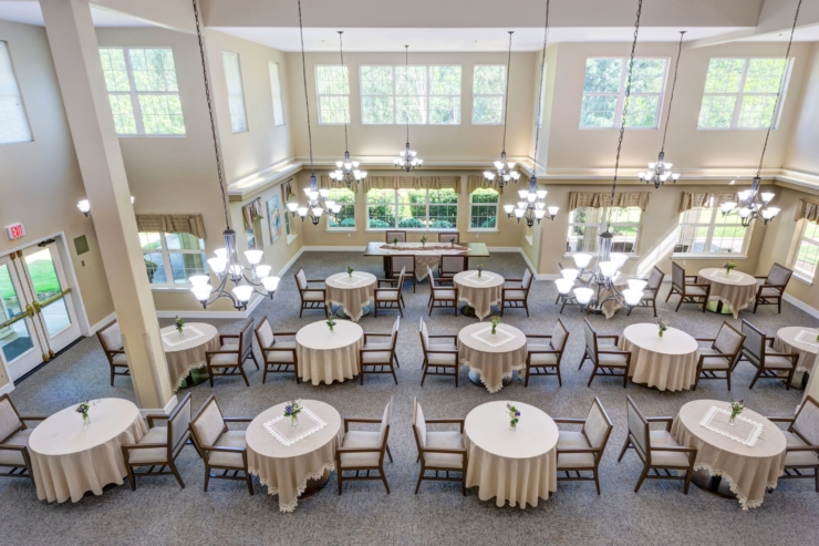 Bright and inviting space with elegantly set tables, fostering warmth and community for residents.