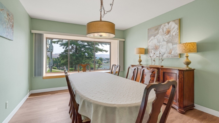A bright dining area invites warm gatherings, showcasing elegant decor and scenic views.