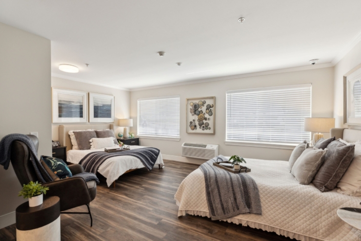 Bright and inviting, this spacious room features two comfortable beds, fostering a sense of community and warmth.