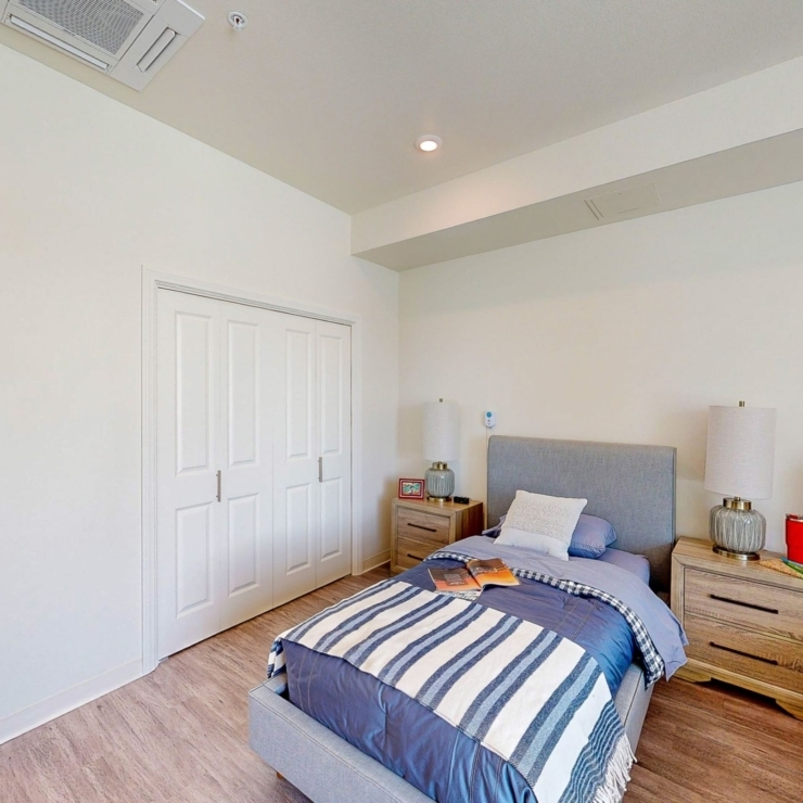 A serene bedroom with warm lighting and inviting decor, perfect for relaxation and comfort.