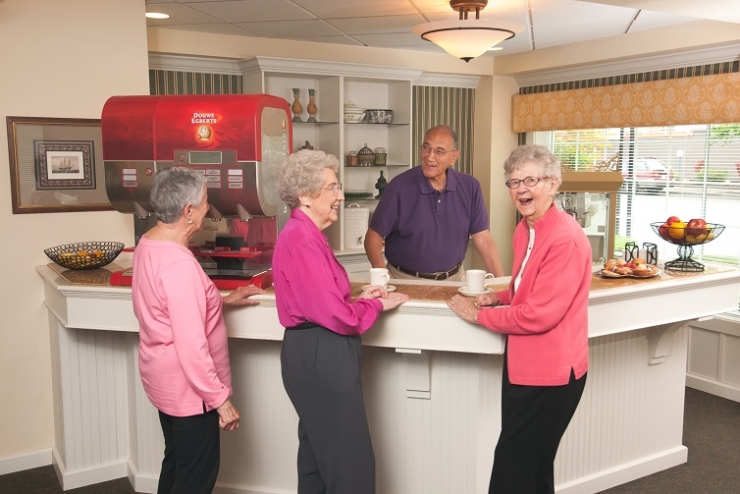 A warm gathering at the community café, where residents enjoy lively conversation and companionship.
