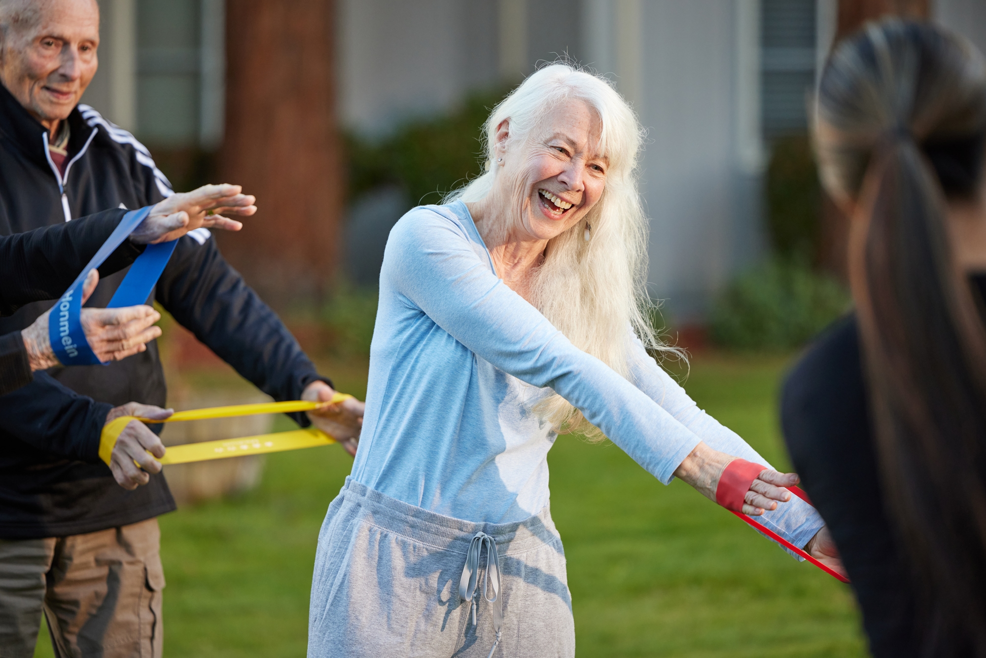 Engaging seniors enjoy a vibrant outdoor exercise class, fostering community and joy.