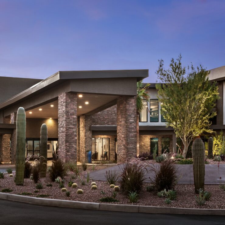 A welcoming entrance surrounded by lush landscaping, inviting residents to a vibrant community.