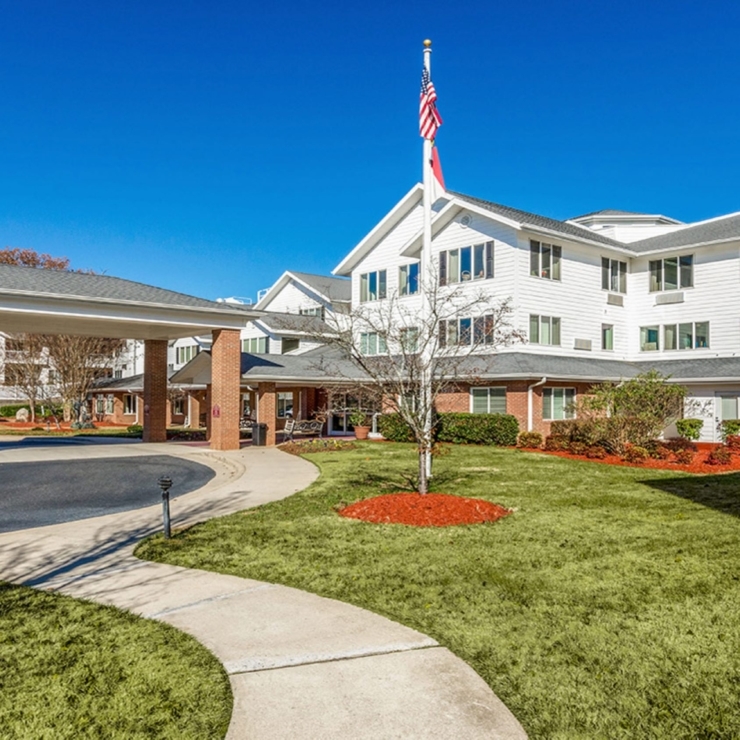 A welcoming entrance surrounded by lush greenery, inviting residents to a vibrant community.