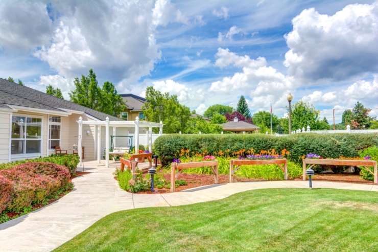 A vibrant garden path leads to cozy seating, inviting a sense of community and tranquility.