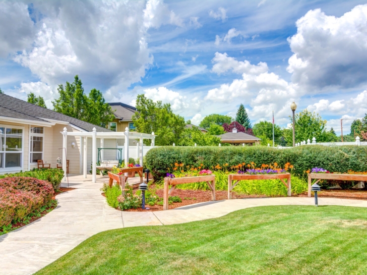 A vibrant garden path leads to cozy seating, inviting a sense of community and tranquility.