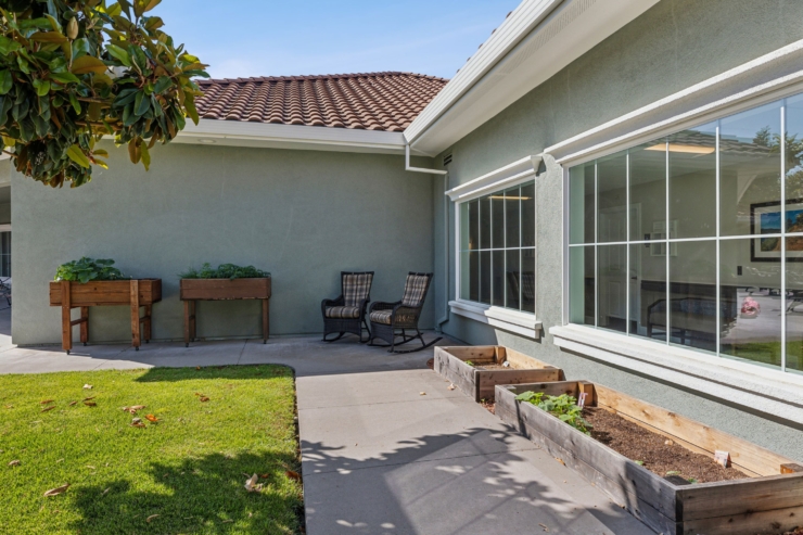 Inviting outdoor space with planters and comfortable seating, perfect for community interaction.