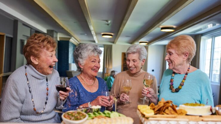 Laughter and joy fill the air as friends share delightful moments over refreshments in a welcoming space.