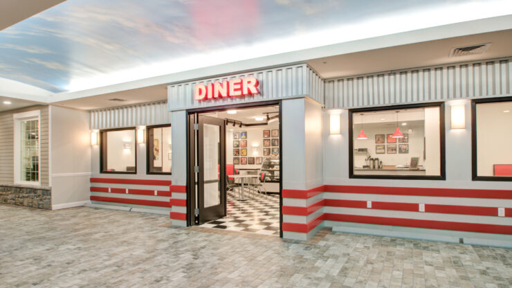Bright and inviting diner entrance with a nostalgic design, fostering a welcoming community space.