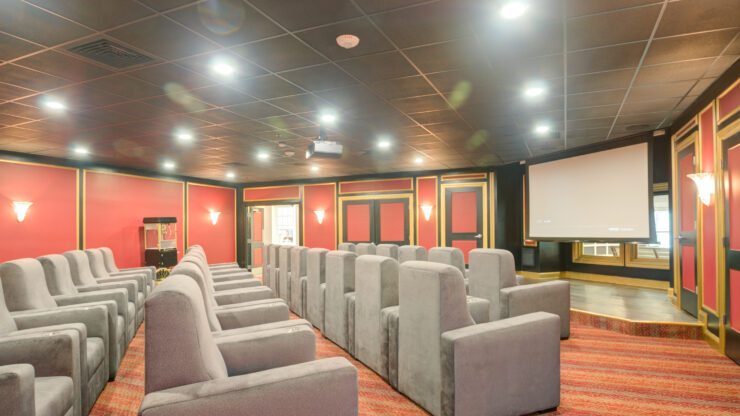 A welcoming theater space with plush seating, perfect for community gatherings and movie nights.