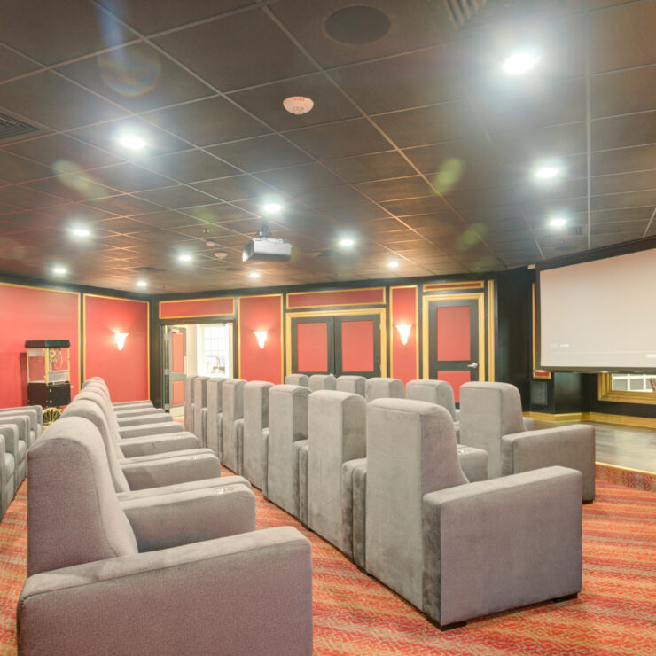A welcoming theater space with plush seating, perfect for community gatherings and movie nights.